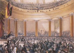 Sitzung der Nationalversammlung in der Frankfurter Paulskirche im Juni 1848, kolorierte Zeichnung von Ludwig von Elliott, 1848. Foto: Wikipedia, File: Frankfurt Nationalversammlung 1848. 